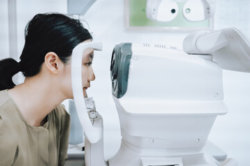 Woman having an eye examination with a modern eye testing machine