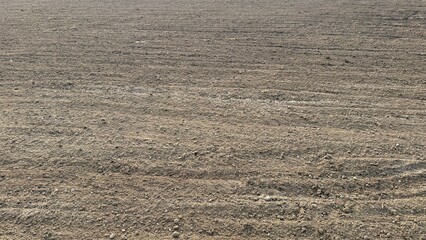 Arable land shows freshly plowed soil that appears ready for seeding new crops