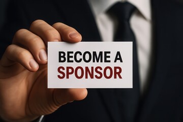 Man in suit holding a business card that says become a sponsor