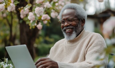 Black elderly man on a laptop outdoors in a garden. Smiling African American senior male enjoying fresh air, communicating on a video call on a computer.Life insurance, Generative AI