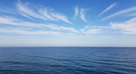 Obraz premium Serene Ocean View, Calm Waters, Clear Sky, Nature Photography, Coastal Perspective