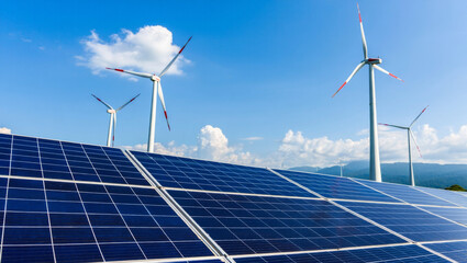 Renewable energy sources with solar panels and wind turbines under a clear blue sky