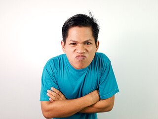 Fototapeta premium Happy Young Asian Man Smiling Positively With Folded Arms in a Blue Shirt