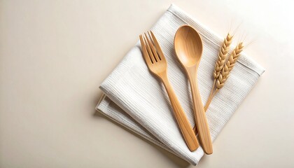 Wooden cutlery set on linen napkin with wheat stalks kitchenware food photography