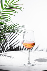 refreshing rose pink wine on a marble table with tropical backdrop for a relaxing moment