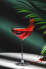 Red italian spritz alcoholic cocktail drink with gentian bitters, juice, sparkling wine and orange twist