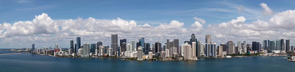 Fototapeta premium Aerial panorama of Brickell in Miami. Downtown Miami skyline on a sunny day. Scenic view of Miami Beach and Brickell. Miamis Skyscrapers. Brickell famous landmarks. Miami downtown landscape.