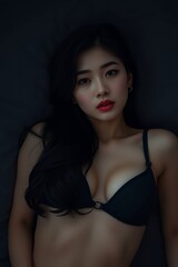 Naklejka premium Confident woman wearing a bra lying gracefully amidst scattered red rose petals, portraying sensual elegance, femininity, and beauty in a romantic, intimate setting