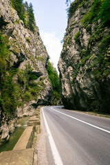 A winding mountain road through the hills of Romania