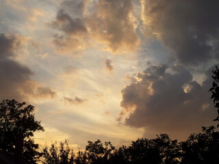 Evening sky with clouds and yellow light 