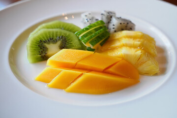 Fresh fruit platter with kiwi mango pineapple and dragon fruit
