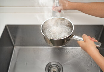 Avoid pouring hot water directly into a sink drain, especially if the pipes are made of PVC or if there are existing clogs, as it can cause damage to the plumbing system.
