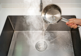 Avoid pouring hot water directly into a sink drain, especially if the pipes are made of PVC or if there are existing clogs, as it can cause damage to the plumbing system.