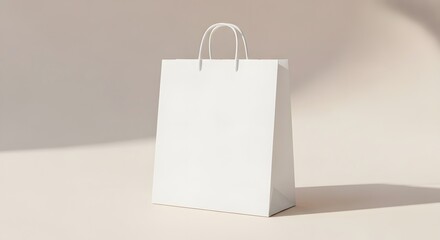 A generic paper bag stands on a neutral-toned surface illuminated by soft light casting subtle shadows emphasizing minimalist aesthetic. The paper bag features white handles for carrying.