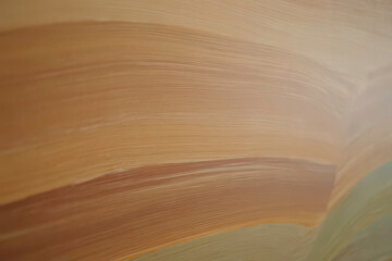 Obraz premium Earthy tones of a layered sandstone formation, a mesmerizing abstract nature background with smooth, flowing patterns.