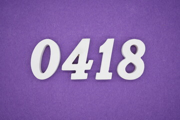 The numbers are made of white painted wood, placed on a purple paper background.
