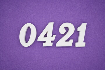 The numbers are made of white painted wood, placed on a purple paper background.