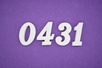 The numbers are made of white painted wood, placed on a purple paper background.