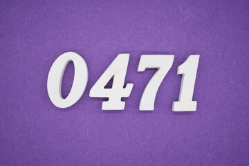 The numbers are made of white painted wood, placed on a purple paper background.