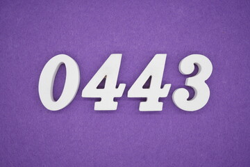 The numbers are made of white painted wood, placed on a purple paper background.