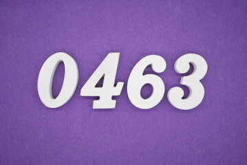 The numbers are made of white painted wood, placed on a purple paper background.