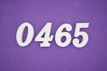 The numbers are made of white painted wood, placed on a purple paper background.