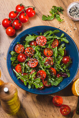 Salad with arugula, cherry tomatoes and olive oil