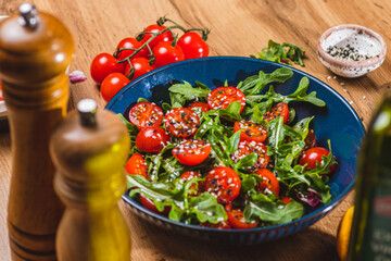 Salad with arugula, cherry tomatoes and olive oil