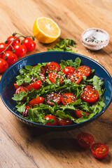 Salad with arugula, cherry tomatoes and olive oil