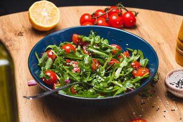 Salad with arugula, cherry tomatoes and olive oil