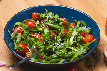 Salad with arugula, cherry tomatoes and olive oil