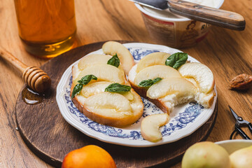 Bruschetta with ricotta and nectarines, garnished with honey and basil