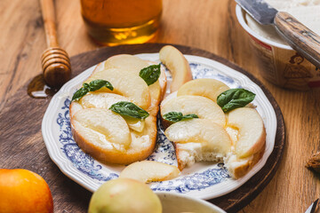 Bruschetta with ricotta and nectarines, garnished with honey and basil