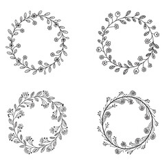 Obraz premium Four black and white floral wreaths with leaves and berries flower