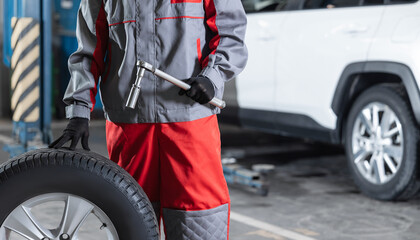 Auto mechanic repair tire in garage workshop. Banner car fix service concept