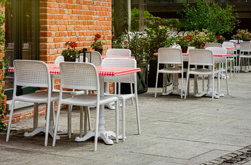 Chairs and tables. Abandoned sidewalk cafe autumn morning	
