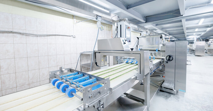 Automated puff pastry production line for spinach filling in confectionery facility, food industry factory