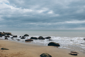Sea waves lash line impact rock on the beach
