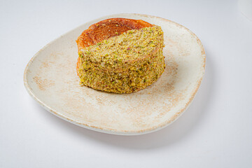 A deliciously crafted dessert slice adorned with colorful toppings rests on an elegant plate