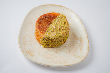A tasty dessert of nuts and pastry awaits on a textured plate, ready to be enjoyed