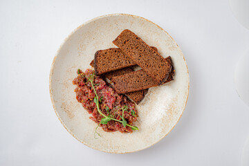 A delicious combination of crispy bread and flavorful beef tartare garnished with greens