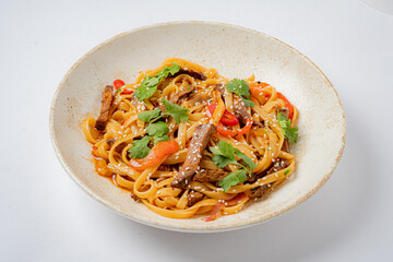 Enjoy stir-fried noodles with tender beef, vibrant veggies, and fresh herbs