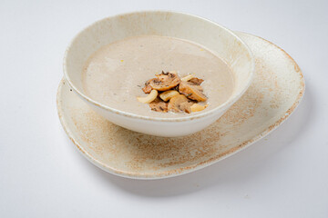 Delicious nut-based soup topped with mushrooms and nuts, offering a rustic culinary experience