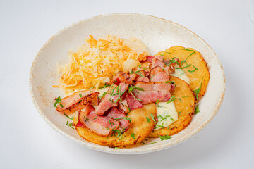 Delicious plate of crispy bacon draped over golden pancakes, paired with fresh cabbage garnish