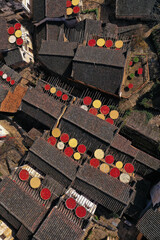 Rural Chinese village harvest season with red and yellow drying goods under sunset