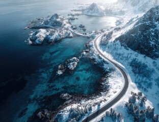 Snowy coastal road winds along a turquoise sea