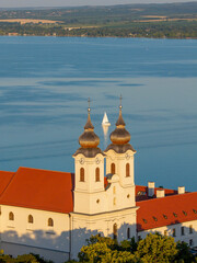Europe Hungary Tihany town. Famous churh what name is Tihany Benedictine Abbey in this photo with sailing boat in background Hungarian name is Tihanyi Bencés apátság
