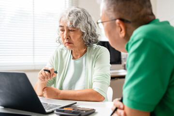 Senior couple with laptop for life insurance documents, home retirement planning or investment with...