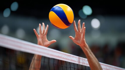 Volleyball player is about to hit the ball with his hands. The ball is in the air and the player is reaching for it