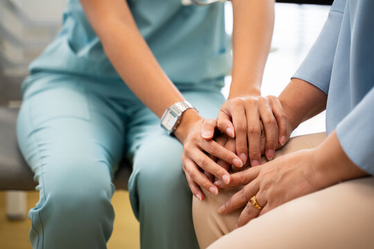 Doctor or Mental health and elderly care concept.Close up hands of doctor or caregiver hands elderly home care or hospital.Arthritis person's hand in support of geriatric nursing caregiver in hospital